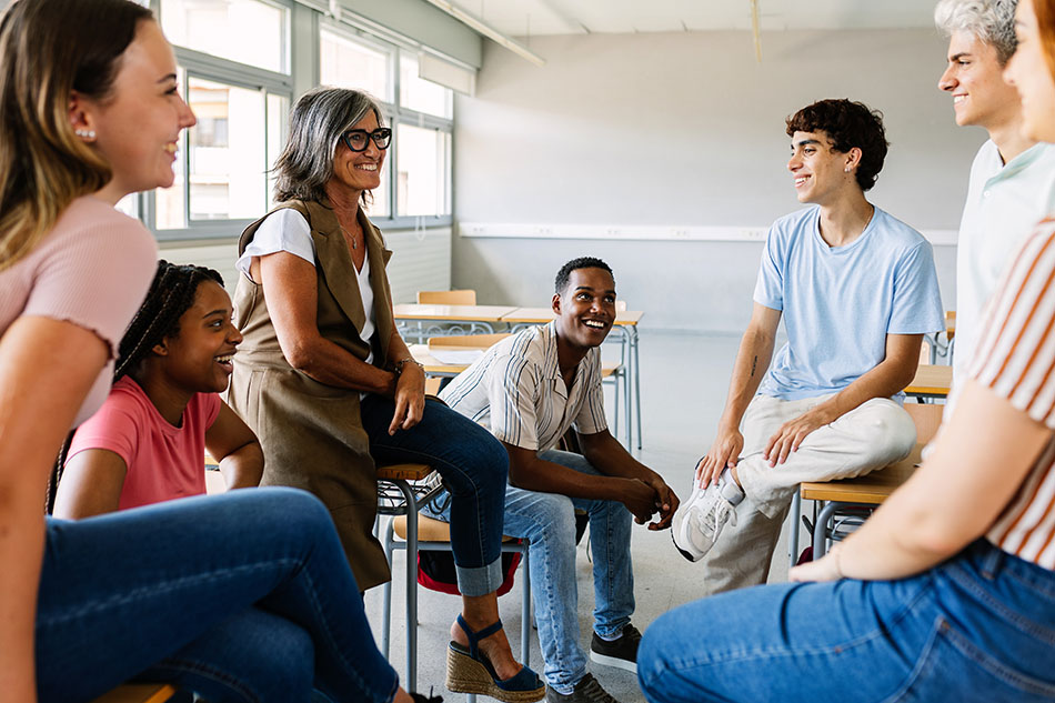 Teens in classroom with teacher